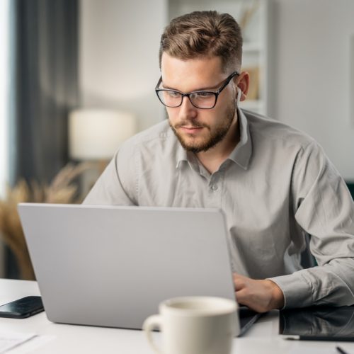 Young,Handsome,Man,Coding,With,At,Laptop,From,Home,,Remote